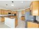 Bright kitchen with wood cabinets, granite counters, stainless appliances, and kitchen island at 8632 Sw 86Th Cir, Ocala, FL 34481