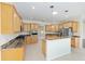 Stylish kitchen boasts wooden cabinets, granite countertops, an island, and modern appliances at 8632 Sw 86Th Cir, Ocala, FL 34481