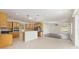 Open kitchen with granite counters, wood cabinets, tile floor and stainless appliances at 8632 Sw 86Th Cir, Ocala, FL 34481