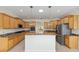 Well-equipped kitchen featuring wooden cabinets, granite countertops, stainless steel appliances, and a kitchen island at 8632 Sw 86Th Cir, Ocala, FL 34481