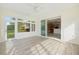 Bright sunroom with wood look flooring and sliding door to the kitchen at 8632 Sw 86Th Cir, Ocala, FL 34481