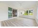 Bright sunroom with wood look flooring and sliding door to the kitchen at 8632 Sw 86Th Cir, Ocala, FL 34481