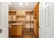 Large walk-in closet with custom shelving and storage, and hardwood floors at 8632 Sw 86Th Cir, Ocala, FL 34481