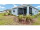 Exterior view of a cozy home with a screened patio, and a well-maintained backyard at 8798 Sw 79Th Pl, Ocala, FL 34481