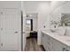 Open view of a bathroom with a quartz countertop and a bedroom with a ceiling fan at 8798 Sw 79Th Pl, Ocala, FL 34481