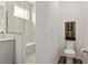 Powder room featuring a window in the tiled shower, along with white finishes at 8798 Sw 79Th Pl, Ocala, FL 34481