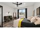 Bedroom with wood-look floors, modern ceiling fan, and a bright window at 8798 Sw 79Th Pl, Ocala, FL 34481