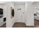 Welcoming entryway with hardwood floors with laundry room to the left and kitchen to the right at 8798 Sw 79Th Pl, Ocala, FL 34481