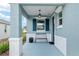 Inviting front porch with elegant columns, a stylish bench, and a charming overhead light fixture at 8798 Sw 79Th Pl, Ocala, FL 34481