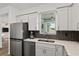 Well-lit kitchen with stainless steel appliances, tiled backsplash, and ample counter space at 8798 Sw 79Th Pl, Ocala, FL 34481