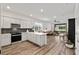 Open-concept kitchen featuring white cabinets, stainless steel appliances, and seamless flow into the living area at 8798 Sw 79Th Pl, Ocala, FL 34481
