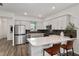 Modern kitchen featuring stainless steel appliances, quartz countertops, and an island with seating at 8798 Sw 79Th Pl, Ocala, FL 34481