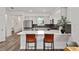 Bright, modern kitchen with stainless steel appliances, quartz countertops, and stylish woven barstools at 8798 Sw 79Th Pl, Ocala, FL 34481