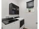 Efficient laundry room featuring modern appliances, cabinet storage, and natural light at 8798 Sw 79Th Pl, Ocala, FL 34481