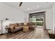 Bright living room with a comfortable couch, stylish lighting, and sliding glass doors at 8798 Sw 79Th Pl, Ocala, FL 34481