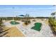 A scenic mini-golf course with artifical greens, landscaping and various hole designs at 8798 Sw 79Th Pl, Ocala, FL 34481