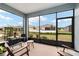 Cozy screened patio with seating, offering a relaxing view of the backyard and neighborhood at 8798 Sw 79Th Pl, Ocala, FL 34481