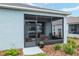 Charming screened patio with seating and a view of the lush backyard landscaping at 8798 Sw 79Th Pl, Ocala, FL 34481