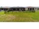 View of the fenced backyard featuring a screened pool and covered patio of the home at 8875 Sw 58Th Street Rd, Ocala, FL 34481