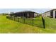 Picture of the home's screened pool, covered patio, and fenced backyard with well-maintained green lawn at 8875 Sw 58Th Street Rd, Ocala, FL 34481