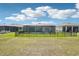 Spacious backyard with screened-in pool, black fencing, and lush green grass at 8875 Sw 58Th Street Rd, Ocala, FL 34481