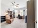A charming bedroom featuring a ceiling fan, a comfy chair, lots of natural light and built in shelving at 8875 Sw 58Th Street Rd, Ocala, FL 34481