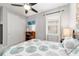 A well lit bedroom with a ceiling fan, large closet, and neutral carpet at 8875 Sw 58Th Street Rd, Ocala, FL 34481