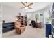 A charming bedroom featuring a ceiling fan, a comfy chair, lots of natural light and built in shelving at 8875 Sw 58Th Street Rd, Ocala, FL 34481