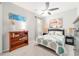 Comfortable bedroom with a ceiling fan, a dresser, and neutral carpet at 8875 Sw 58Th Street Rd, Ocala, FL 34481