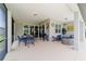Expansive covered patio featuring dining and seating areas for relaxing and entertaining in style at 8875 Sw 58Th Street Rd, Ocala, FL 34481