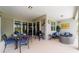 This spacious covered patio is furnished with an outdoor dining area and a comfortable seating area at 8875 Sw 58Th Street Rd, Ocala, FL 34481
