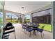 The covered patio is furnished with an outdoor dining table set with views of the backyard at 8875 Sw 58Th Street Rd, Ocala, FL 34481