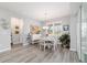 Bright dining room boasts wood floors, stylish lighting, and sliding doors to outdoor living space at 8875 Sw 58Th Street Rd, Ocala, FL 34481