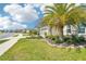 Beautiful home featuring a well-maintained lawn and front yard with a mature palm tree at 8875 Sw 58Th Street Rd, Ocala, FL 34481