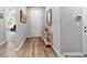 Welcoming foyer with hardwood floors, neutral paint, decorative mirror, and convenient coat closet at 8875 Sw 58Th Street Rd, Ocala, FL 34481