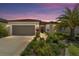 Charming single-story home boasts lush landscaping, a two-car garage, and a welcoming front entrance at 8875 Sw 58Th Street Rd, Ocala, FL 34481