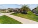 Well-maintained home with a manicured lawn, mature palm tree, and a two-car garage at 8875 Sw 58Th Street Rd, Ocala, FL 34481