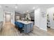 Open kitchen boasts gray cabinetry, stainless steel appliances, and a large island with seating at 8875 Sw 58Th Street Rd, Ocala, FL 34481