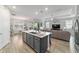 Open-concept kitchen with island seating flows into the dining and living areas, great for entertaining at 8875 Sw 58Th Street Rd, Ocala, FL 34481