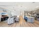 Bright, open-concept living room showcasing modern decor and an adjacent kitchen with a large center island at 8875 Sw 58Th Street Rd, Ocala, FL 34481