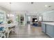Open-concept living space featuring wood floors, backyard access, and a living room with tray ceilings at 8875 Sw 58Th Street Rd, Ocala, FL 34481