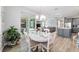 Spacious open-concept living space and backyard access via sliding glass doors fill this home with light at 8875 Sw 58Th Street Rd, Ocala, FL 34481