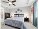 Spacious main bedroom featuring neutral decor, ceiling fan, and ensuite bathroom at 8875 Sw 58Th Street Rd, Ocala, FL 34481