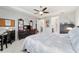 Neutral main bedroom featuring a desk area, ceiling fan, and access to an ensuite bathroom at 8875 Sw 58Th Street Rd, Ocala, FL 34481