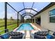Relax by the screened pool, complete with waterfall feature, and lounge chairs for serene outdoor enjoyment at 8875 Sw 58Th Street Rd, Ocala, FL 34481