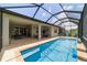A screened-in pool and patio area offers both a pool and a lounge seating area for outdoor enjoyment at 8875 Sw 58Th Street Rd, Ocala, FL 34481