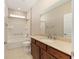 Well-lit bathroom featuring a shower-tub combo, neutral color palette, and a large countertop at 8952 Sw 79Th Ln, Ocala, FL 34481