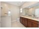 Bathroom with double vanity, granite countertops, and a walk-in shower with tile surround at 8952 Sw 79Th Ln, Ocala, FL 34481
