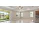 Spacious living room with tile floors, sliding glass doors, and a ceiling fan at 8952 Sw 79Th Ln, Ocala, FL 34481