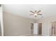 Spacious main bedroom featuring a ceiling fan, and an ensuite bathroom with a separate walk-in closet at 8952 Sw 79Th Ln, Ocala, FL 34481